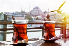 shutterstock_352487714-Turkish-tea-cup-on-the-background-of-port-in-Istanbul